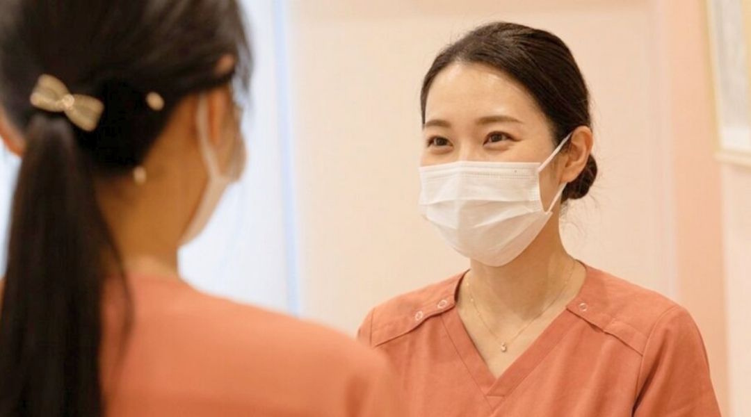 笑顔で話を聞く看護師